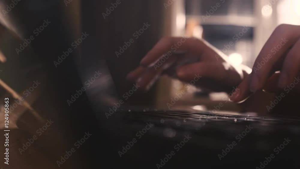 Woman typing a message on a laptop at night slowmonion closeup Woman typing a message on a laptop at night slowmonion closeup