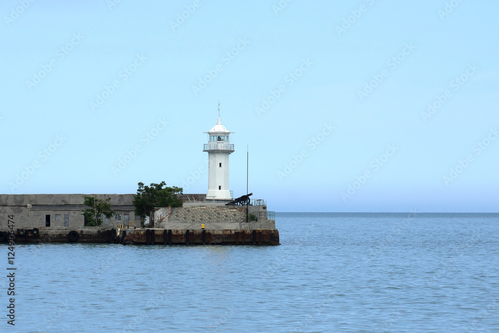Beacon mounted on the edge of the concrete pier at the port of Yalta, which partially block off the entrance to Yalta Bay Beacon mounted on the edge of the concrete pier at the port of Yalta, which partially block off the entrance to Yalta Bay