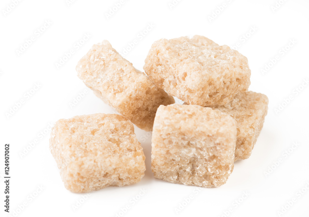 pieces of brown cane sugar isolated on white background. pieces of brown cane sugar isolated on white background.