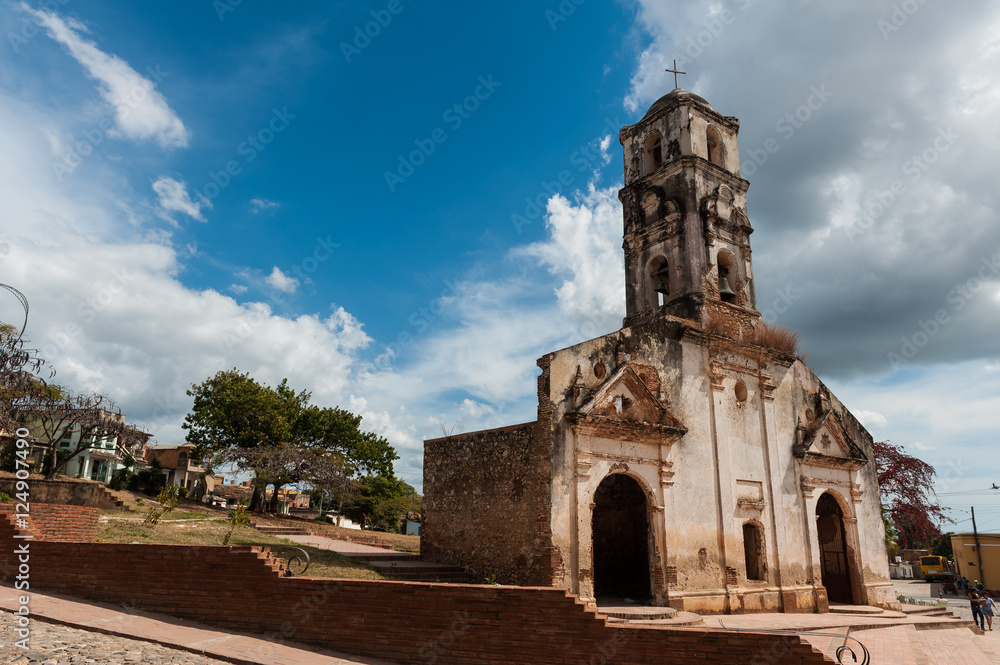 Old colonial church on a square in Trinidad, Cuba, with a sunny