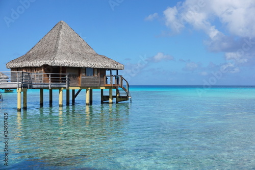 Overwater bungalow with thatched roof in the lagoon of Rangiroa, south Pacific ocean, Tuamotu, French Polynesia 