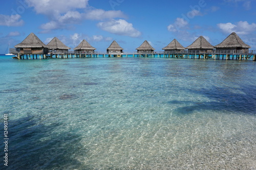 Overwater bungalows in the lagoon, seen from the seashore, Rangiroa atoll, south Pacific ocean, Tuamotu, French Polynesia 