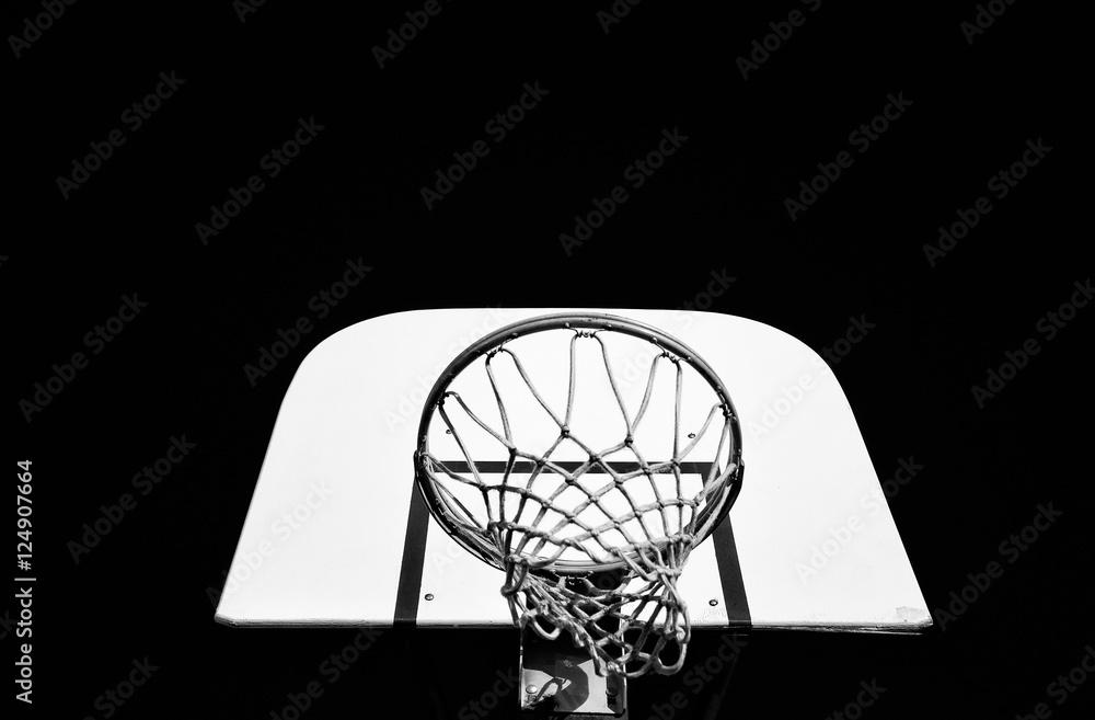 An outdoor basketball net and backboard in black and white