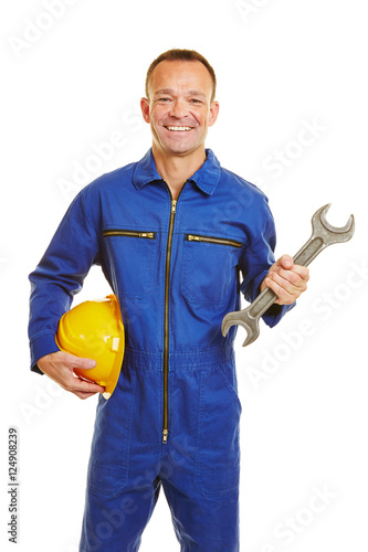 Mechanic in jumpsuit with helmet and jaw wrench