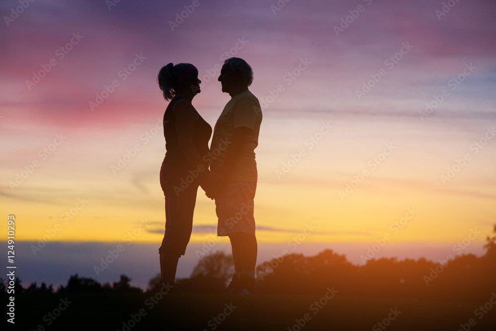 Couple on evening background. People standing and holding hands. Spend eternity with you. Time and loyalty.