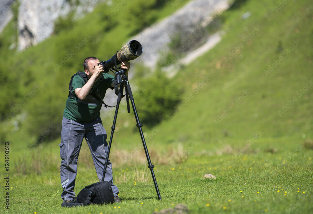 Professional travel on location and nature videographer/photographer (man) photographing and video nature and landscape outdoor.