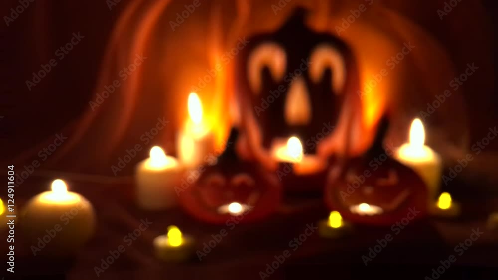 Spooky Halloween Jack-o-Lanterns glowing on a bright orange background with mysterious defocus distortion Spooky Halloween Jack-o-Lanterns glowing on a bright orange background with mysterious defocus distortion