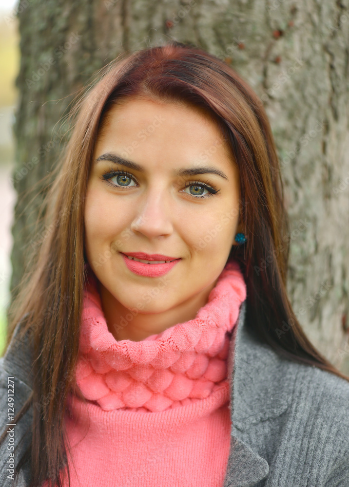 Portrait of beautiful young woman outdoors in autumn