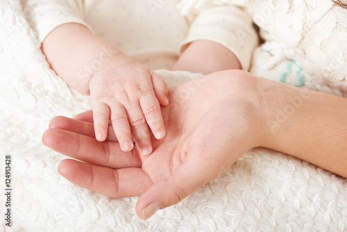 baby and mother hand closeup, happy maternity concept