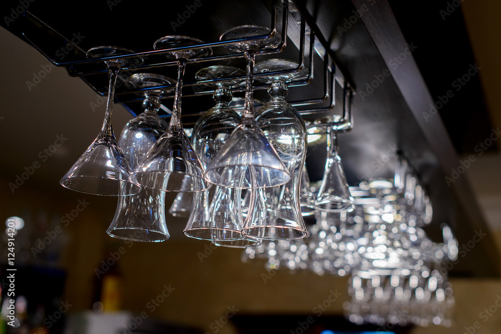 Empty glasses for wine above a bar rack. Empty glasses for wine above a bar rack.
