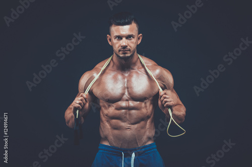 Muscular man skipping rope. active sport fitness 
