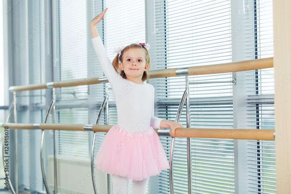 The young girl dances in a ballet tutu in the hall The young girl dances in a ballet tutu in the hall