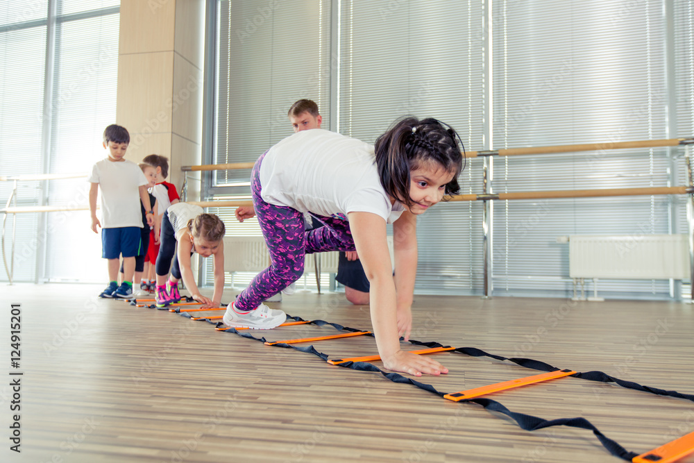 Obraz premium Happy sporty children in gym.
