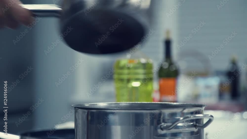 Pan on the stove. Transfusion of water. In a saucepan pour the water. The steam from cooking. Metal pan. Cooking. Cooking of soup. First course. Cooking restaurant meal. Pan on the stove. Transfusion of water. In a saucepan pour the water. The steam from cooking. Metal pan. Cooking. Cooking of soup. First course. Cooking restaurant meal.
