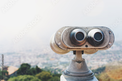 Touristic telescope look at the city with view of Barcelona Spain, close up old metal binoculars on background viewpoint overlooking the mountain, hipster coin operated in panorama observation, mockup