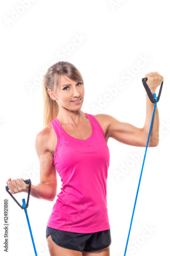 Beautiful young fitness trainer standing isolated over white bac