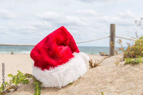 Christmas hat on the sand/Red xmas hat at tropical beach