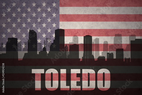 abstract silhouette of the city with text Toledo at the vintage american flag