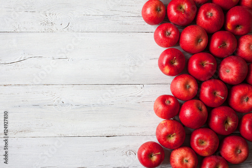 Wooden background with red apples