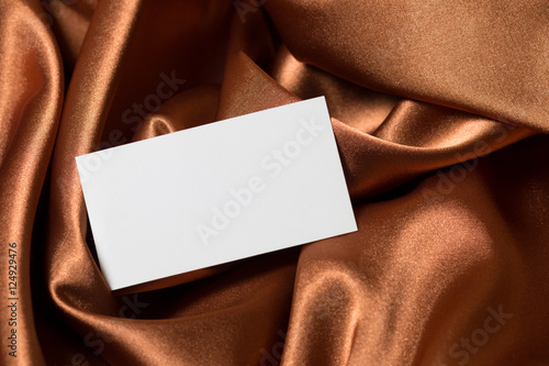 card on gold fabric background