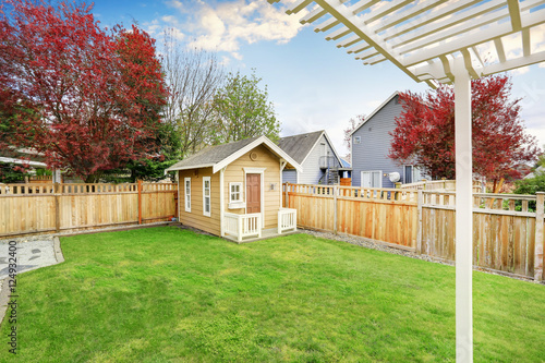 Small wooden shed in the back yard photo