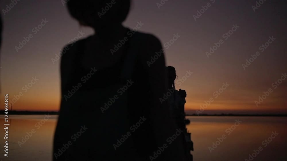 Friends walking on pier near sea at sunrise Slow motion Friends walking on pier near sea at sunrise Slow motion