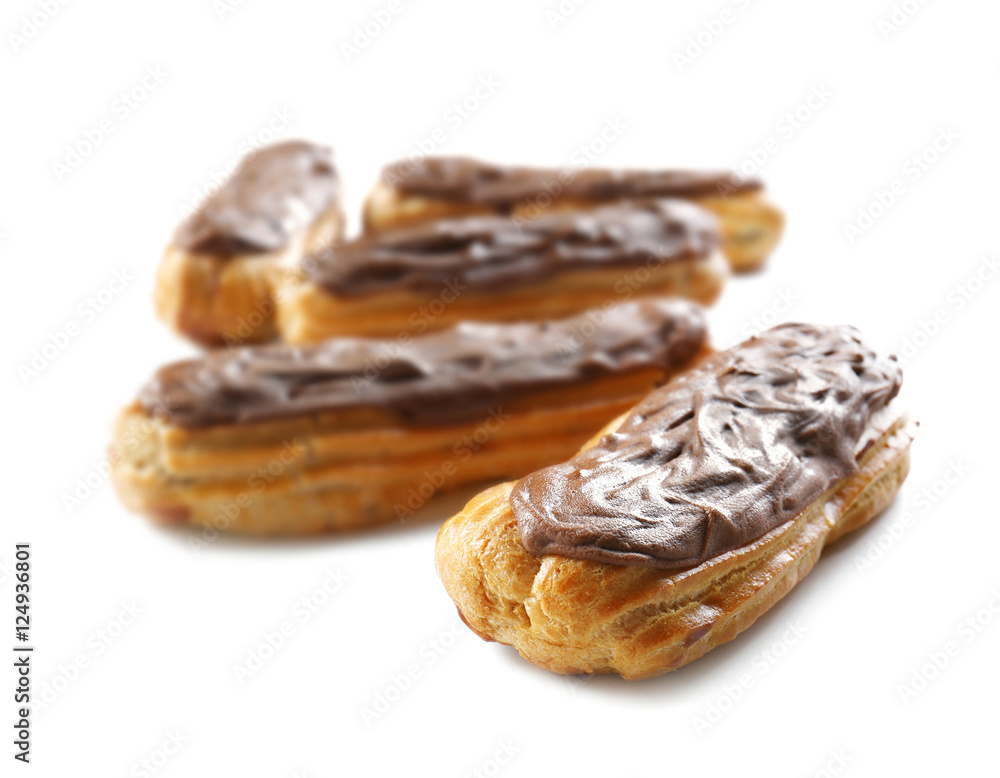 Delicious eclairs with chocolate in a row on white background