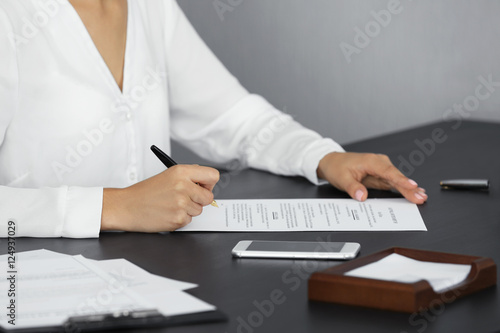 Woman signing important doc...