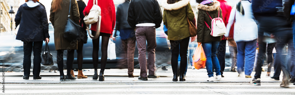 people waiting at the pedestrian crossing