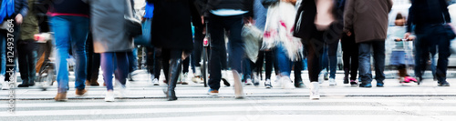 crowd of people crossing a city street