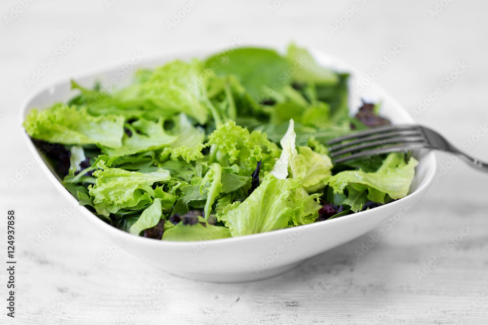 Fresh delicious salad on white wooden background, closeup Fresh delicious salad on white wooden background, closeup
