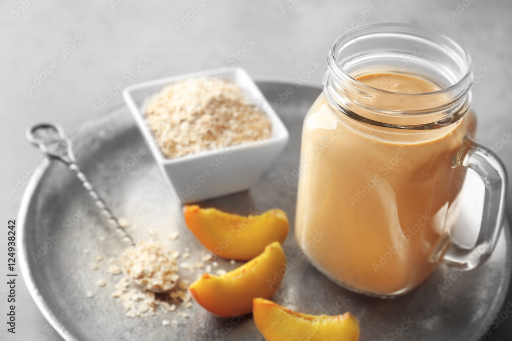 Mason jar with tasty smoothie and some ingredients on kitchen table Mason jar with tasty smoothie and some ingredients on kitchen table