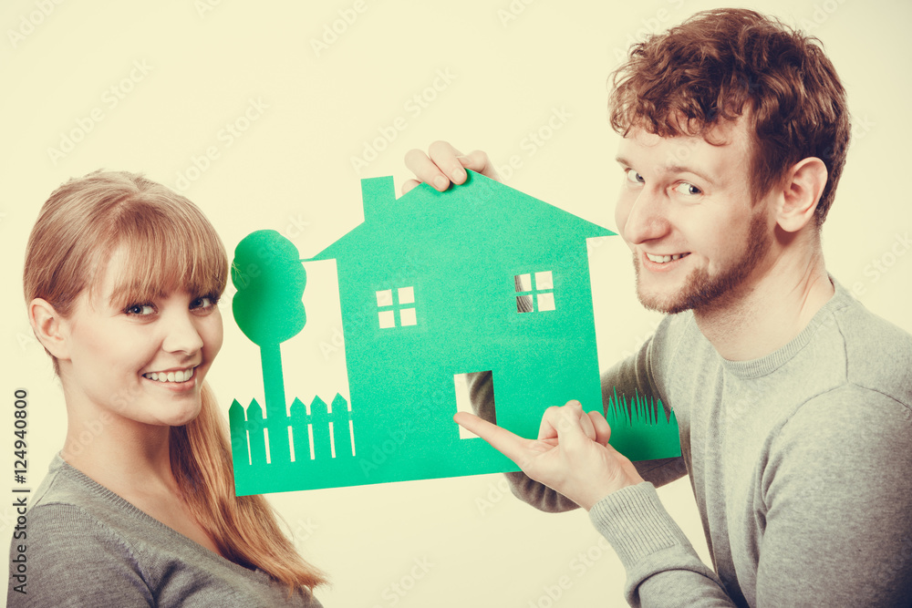 Young couple with ecological green house. Young couple with ecological green house.