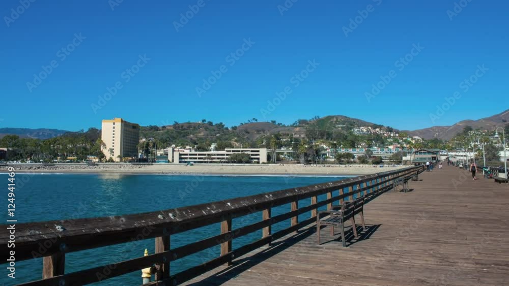 Time lapse of stroll down Ventura Pier with tourist hotel in distance. Time lapse of stroll down Ventura Pier with tourist hotel in distance.