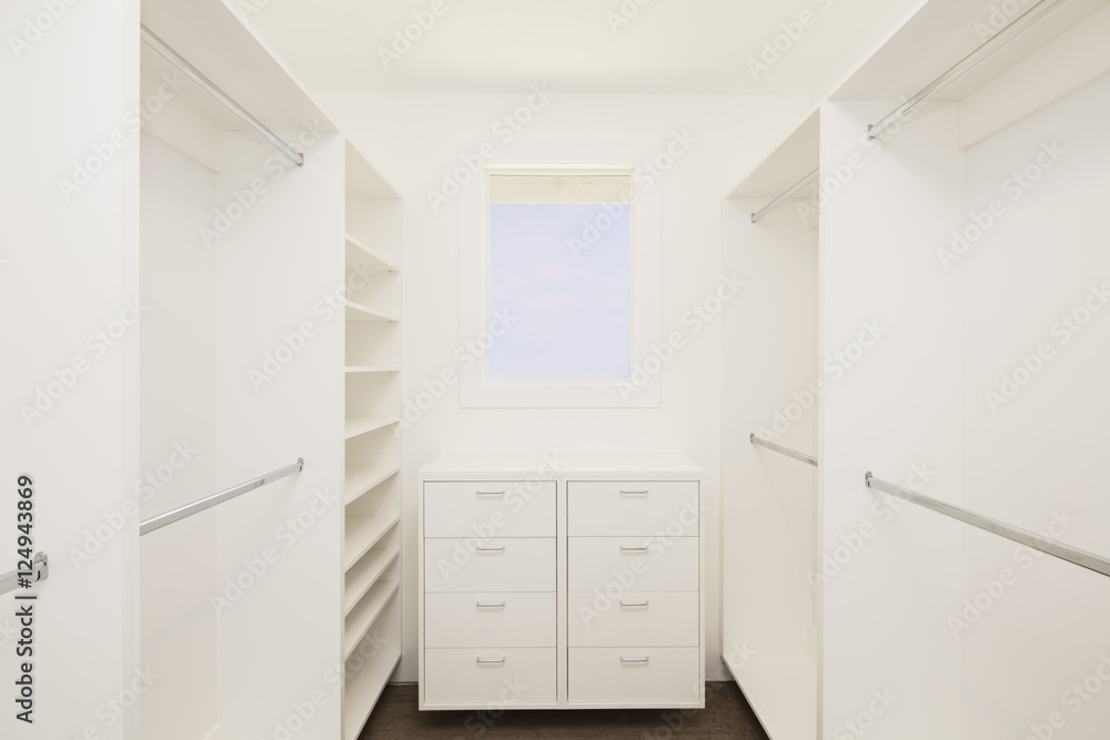 Big empty walk in wardrobe / closet in luxurious house. Big empty walk in wardrobe / closet in luxurious house.