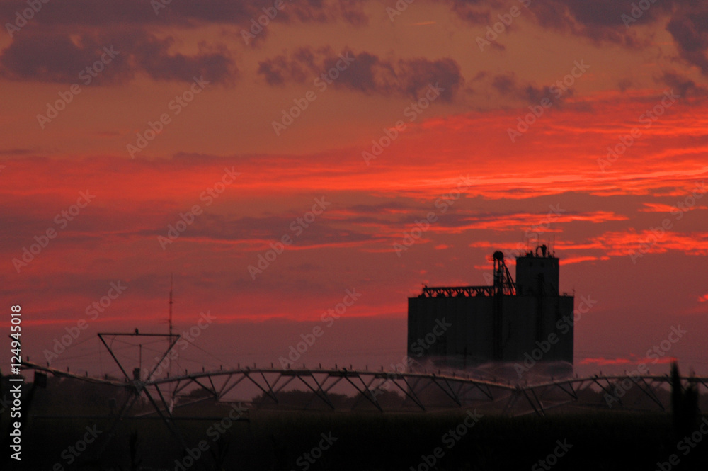 Fototapeta premium Sunset with Grain Elevator and Irrigation Pivot