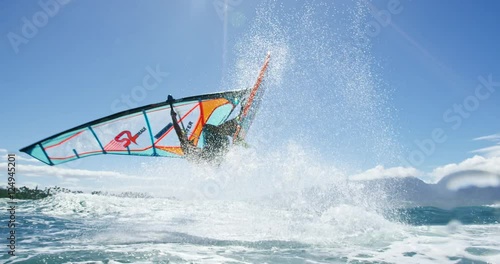 Windsurfer gets big air jumping off wave, Extreme sport