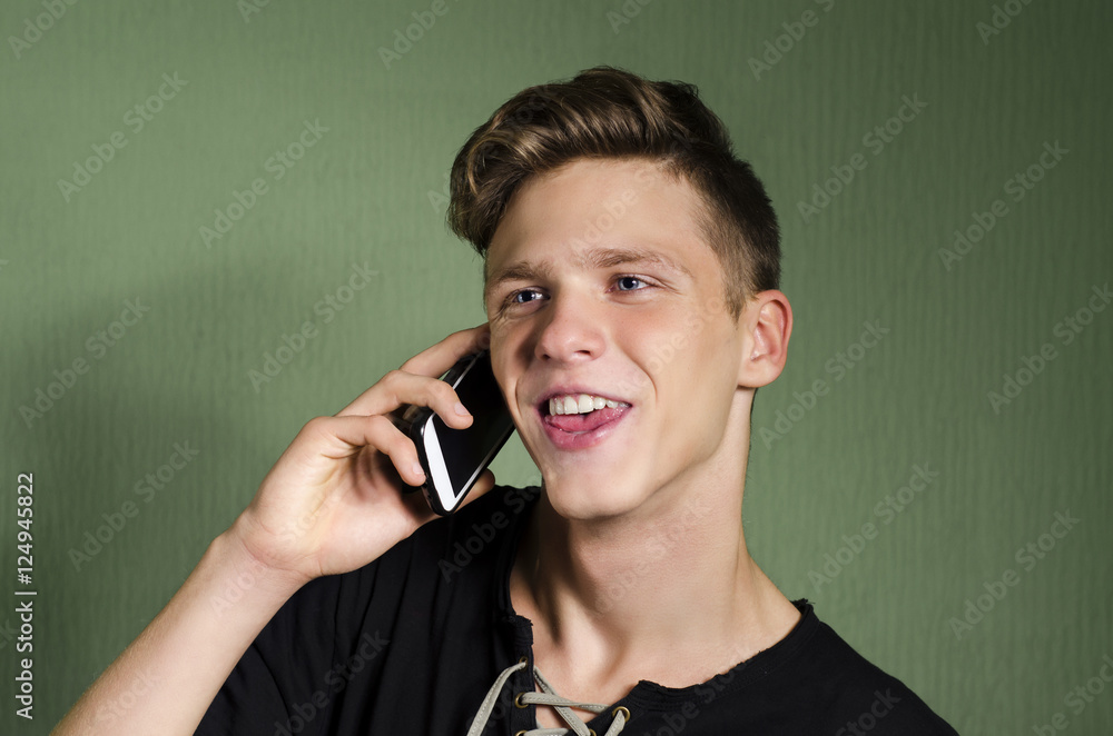 Portrait of cool millennial using smartphone and laughing Portrait of cool millennial using smartphone and laughing