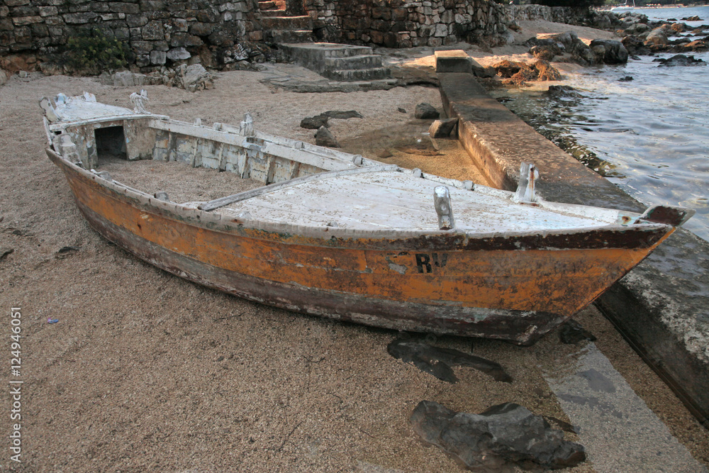 old wood boat on sand