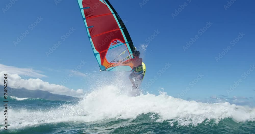 Windsurfer gets big air jumping off wave, Extreme sport Windsurfer gets big air jumping off wave, Extreme sport