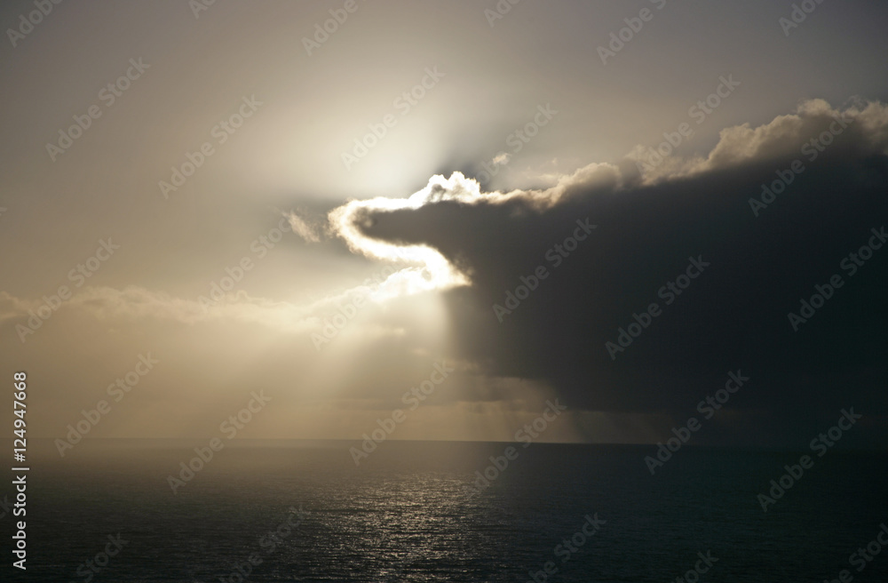 clouds obscuring sun over ocean