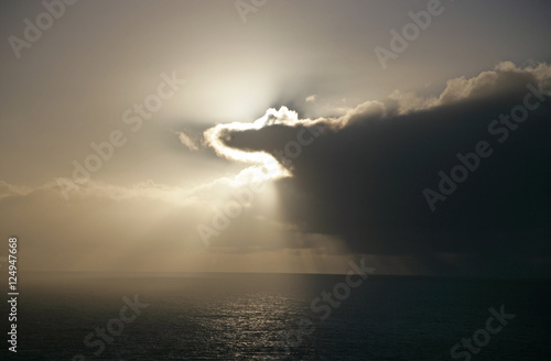 clouds obscuring sun over ocean