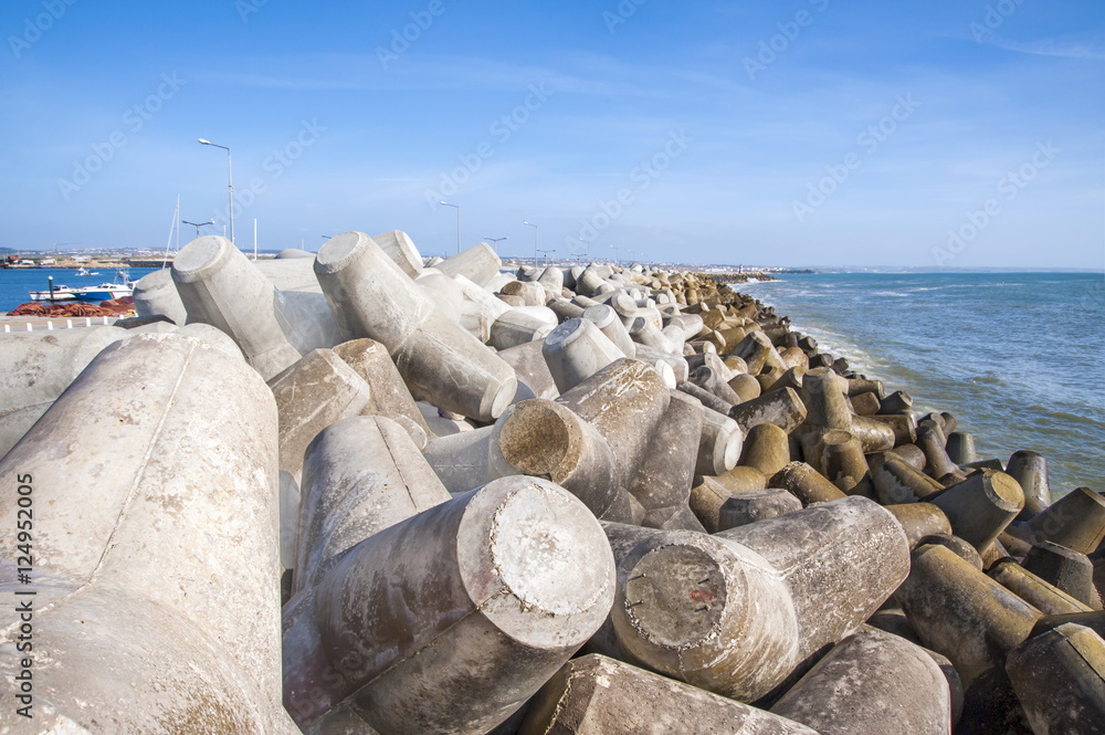 Breakwater in Portugal seashore formed by concrete blocks Breakwater in Portugal seashore formed by concrete blocks