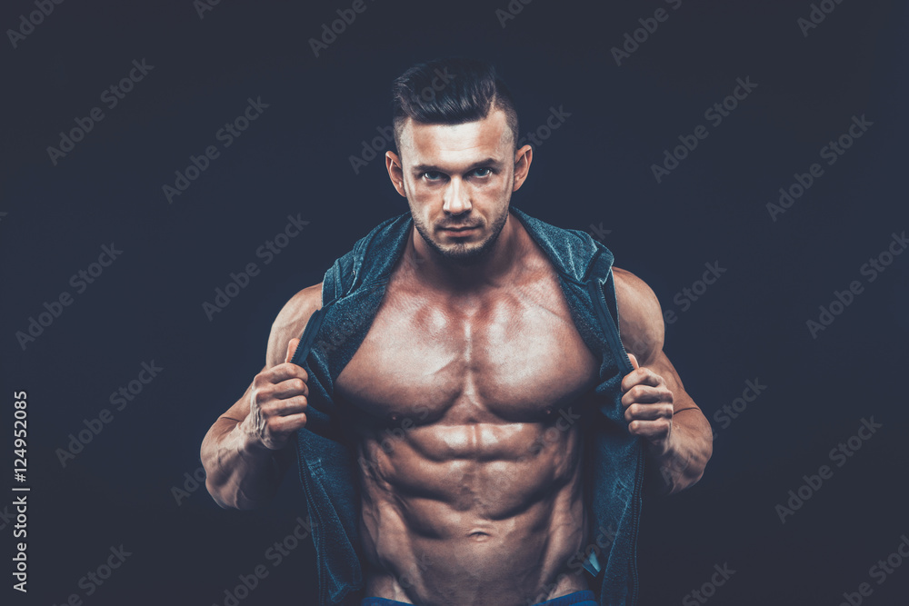 strong athletic man on black background strong athletic man on black background