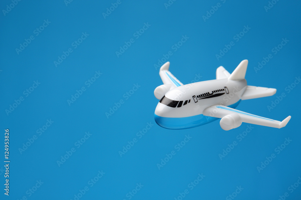 Naklejka premium plastic toy plane flying on blue background