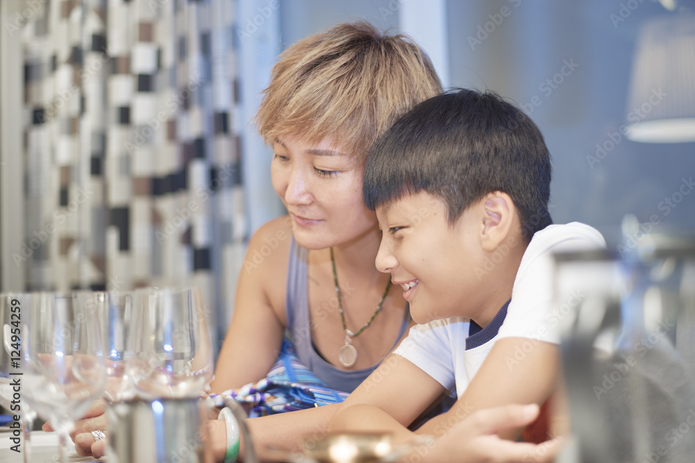 young mother and son in dining room enjoying young mother and son in dining room enjoying