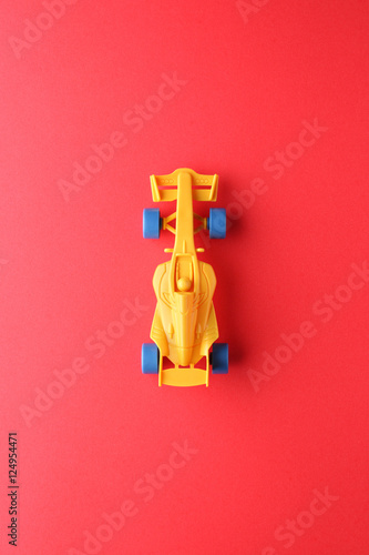 racing car toy on red paper background