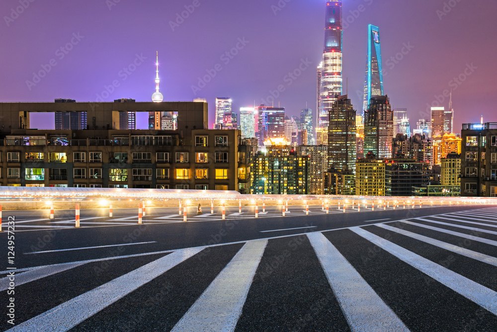 Obraz premium empty asphalt road through modern city in China.