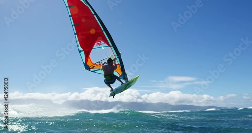 Windsurfer gets big air jumping off wave, Extreme sport