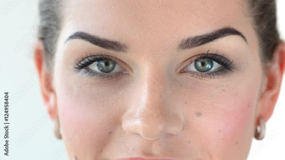 Woman looks into the camera. She opens and closes her eyes. Video of half face. Woman looks into the camera. She opens and closes her eyes. Video of half face.